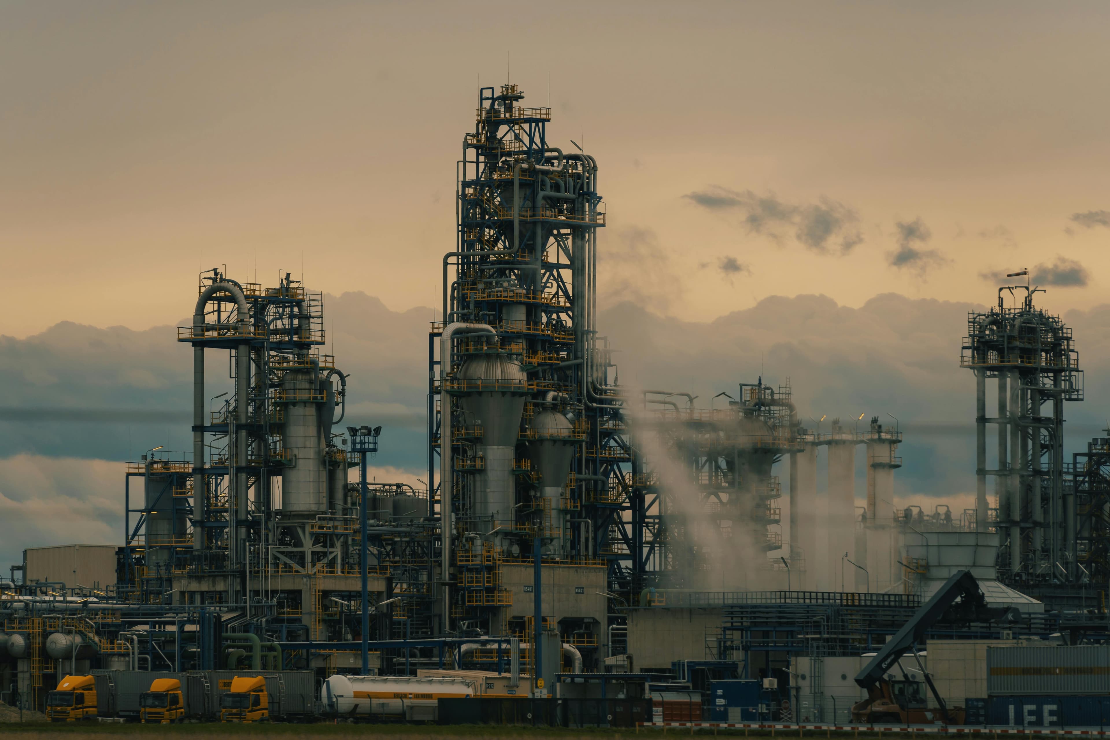 Industrial refinery towers at dusk